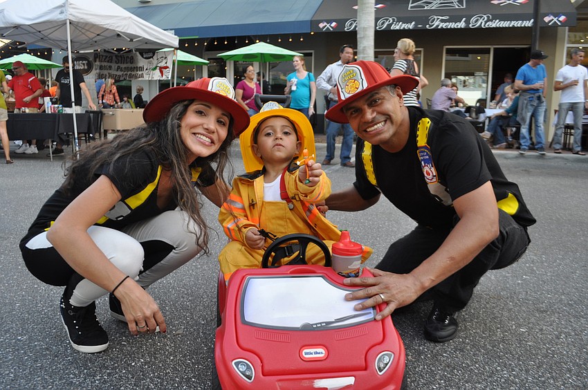 Clara, Miguel and Odimeer Arango all dressed as firemen.