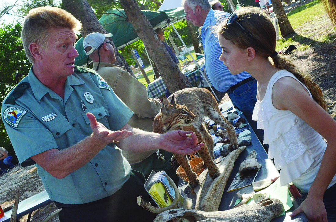 Wendell Vaught educates Emma Griffith about state parks at last yearÃ¢â‚¬â„¢s festival.