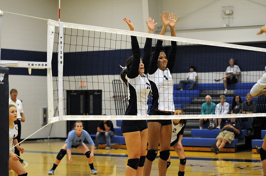 Juniors Monica Costa and Reanna Gregory go up for a block in the second set.