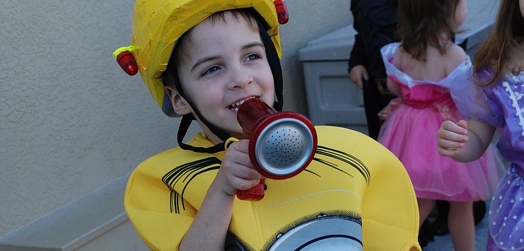 Beckett Smith, 4, "honked" at the crowd, during a Halloween-themed parade at The Goddard School.