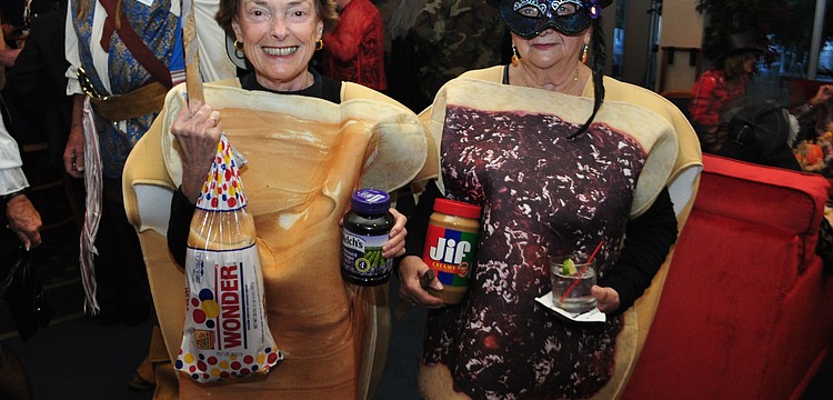 Audrey Singer and Vicky Urban make a sandwich.