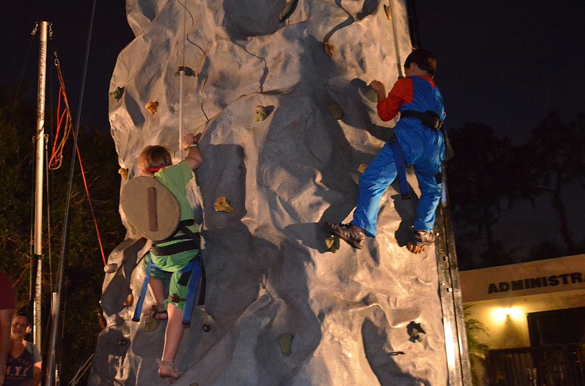 Jordan Spencer and Ethan Dobson climb the rock wall.