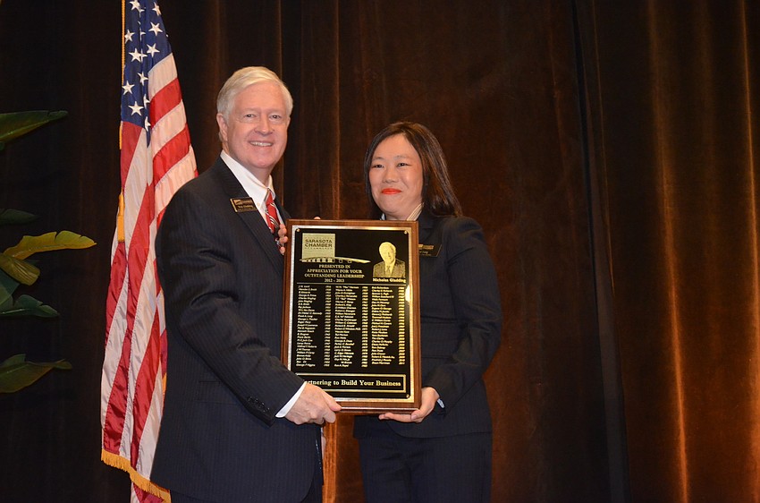 Board Chair Nick Gladding was presented a plaque of appreciation by new Chair Lisl Liang