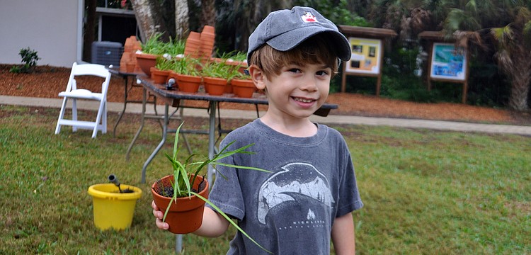 Max Majorski, 3, makes plans for his new plant.