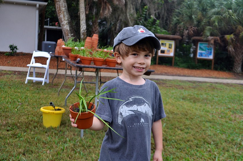 Max Majorski, 3, makes plans for his new plant.