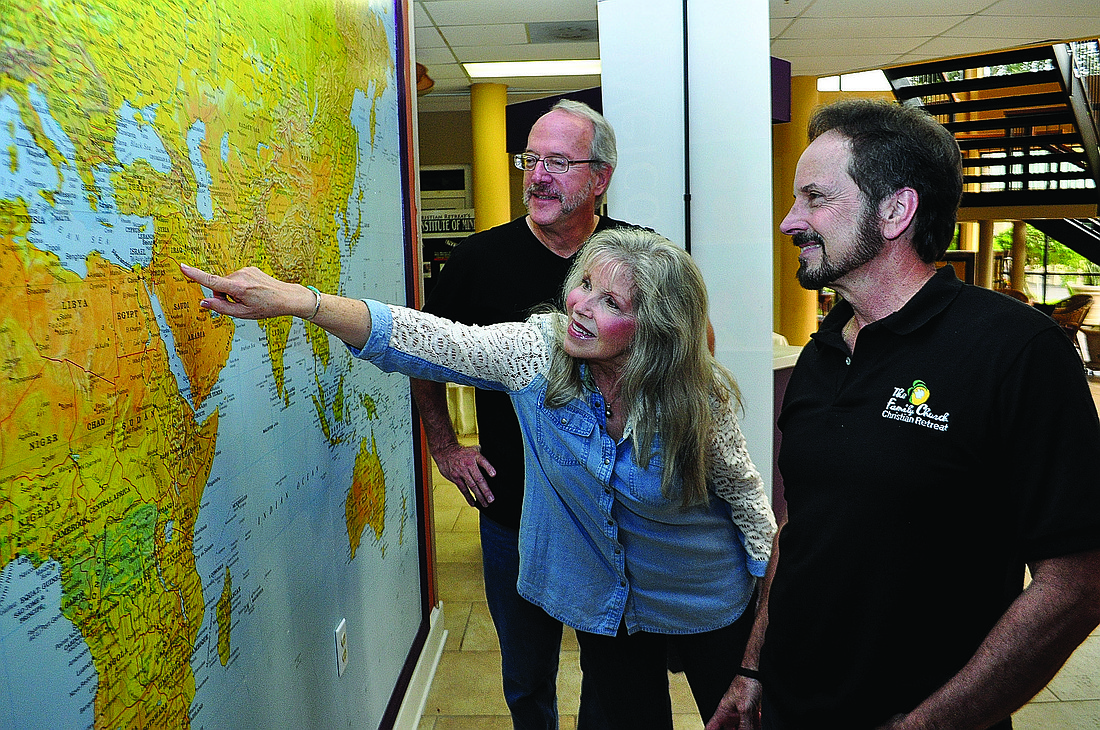 Bill and Joanne Curphey and Phil Derstine show their destination on a map.