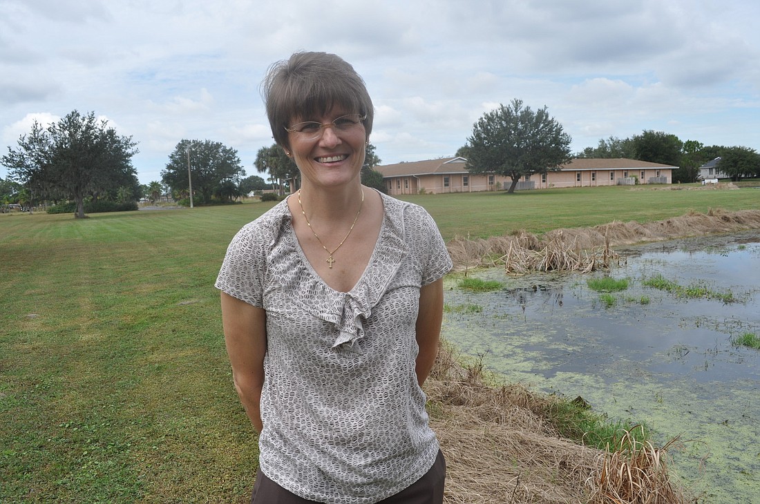 Pastor Elizabeth Deibert will finally get the keys to her churchÃ¢â‚¬â„¢s new home (background) this afternoon. The property has lush green space and a pond.