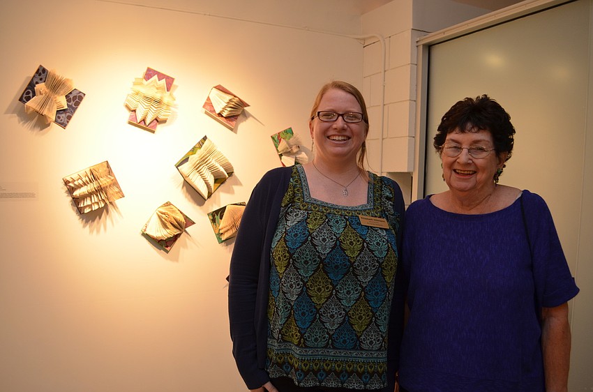 Artist Elizabeth Hillman and Laura Reed stand in front of Hillmanâ€™s piece. Hillman will teach a workshop on â€œThe Art of Marblingâ€ Nov. 19 at Art Center Sarasota.