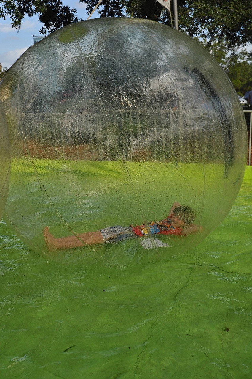 Tyler Horner, 10, relaxed momentarily in the walking water bubble.