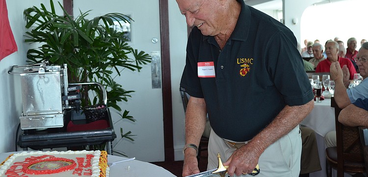 Ralph Franklin cuts the cake.