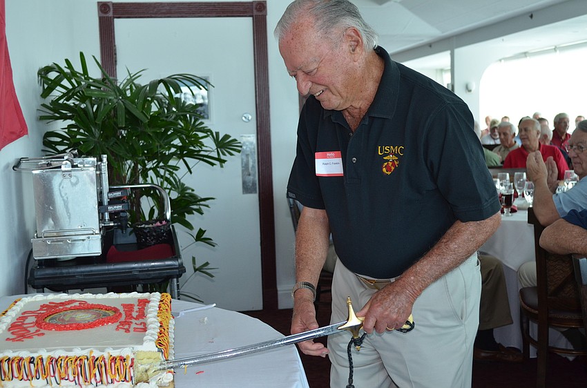Ralph Franklin cuts the cake.