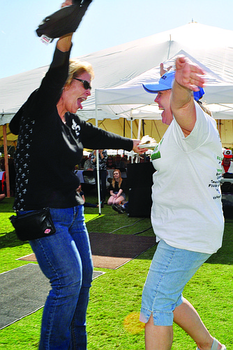 JoAnn Mixon and Sandi Henley celebrate last year after learning that the raffle ticket they purchased with two Town Hall coworkers had the winning number.