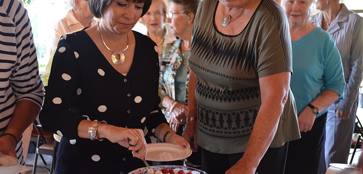 Debbie Shapiro serves herself some trifle