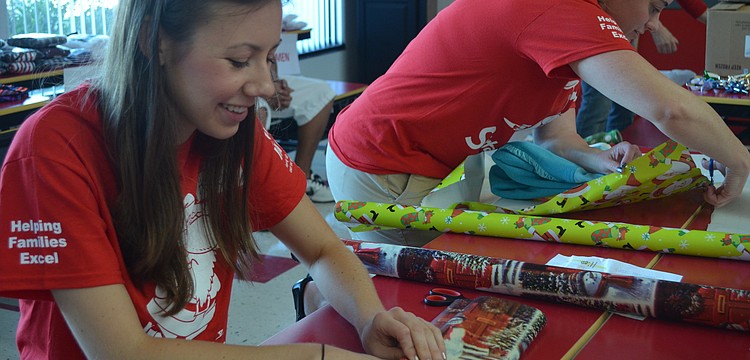 Ashley Light from YPG wraps a gift