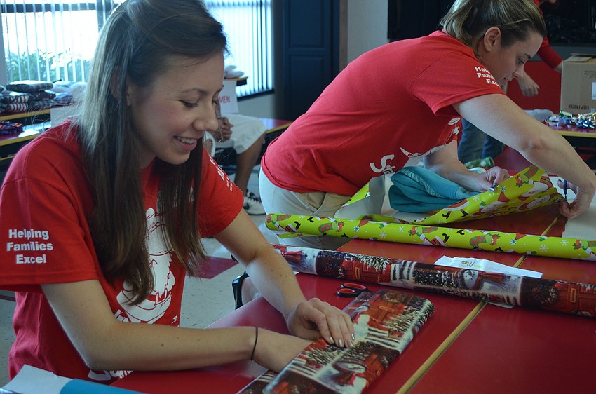 Ashley Light from YPG wraps a gift