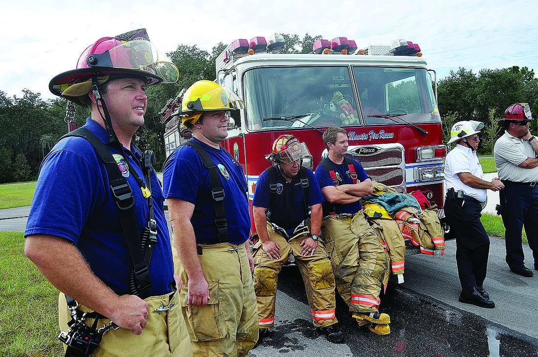 In training, the East Manatee Fire Department firefighters, with their trainer, Mike Bloski, far right, of Hot Zone USA, work together to stop leaking fluids.