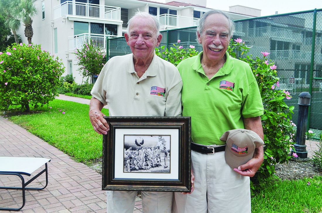Harber Hall, with friend Ronald Emmerman, holds a picture from his time in the U.S. Air Force during World War II.