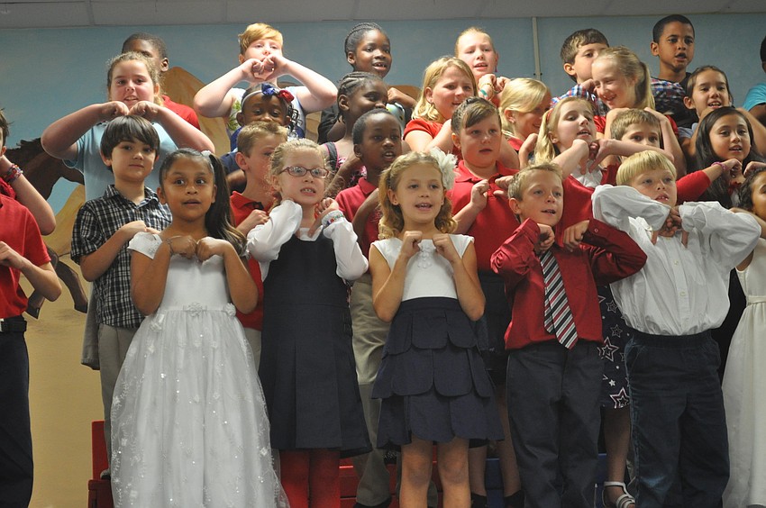 Third graders sang songs about America.
