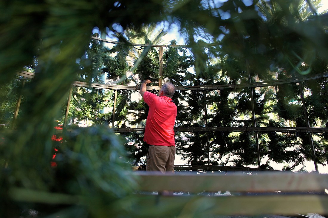 Kurt Hennard inspects the middle section of the tree before itÃ¢â‚¬â„¢s placed.