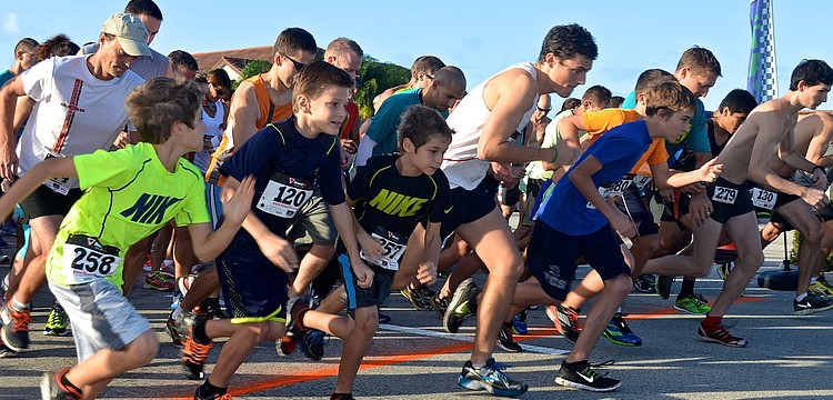 Runners sprint from the starting line.