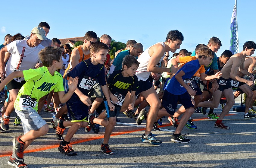 Runners sprint from the starting line.
