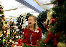 Vivian Leahy laughs as she turns on the lights for one of the decorated trees.