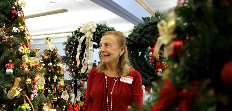 Vivian Leahy laughs as she turns on the lights for one of the decorated trees.