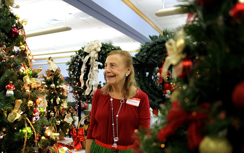 Vivian Leahy laughs as she turns on the lights for one of the decorated trees.