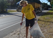 Jeanne Ezcurra picks up trash on Higel Ave.