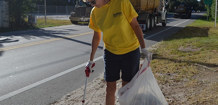 Jeanne Ezcurra picks up trash on Higel Ave.