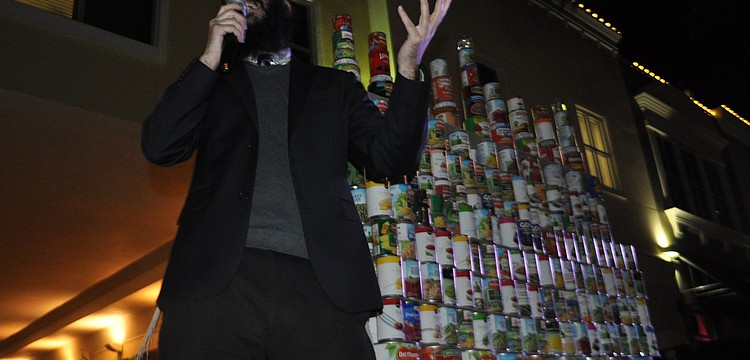 Rabbi Mendy Bukiet explains the menorah is made of cans, because it was the first time Hannukah overlapped with Thanksgiving.