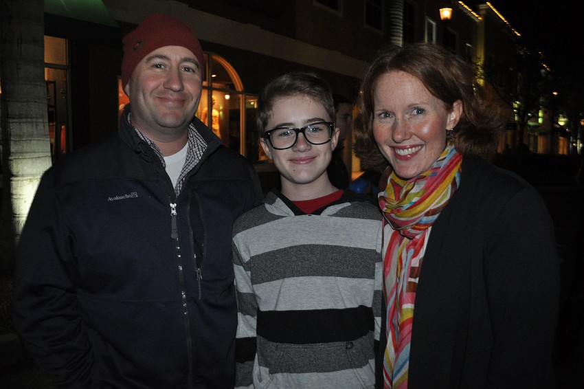 Brad, Jack and Jen Kaiser try food after watching the ceremony.