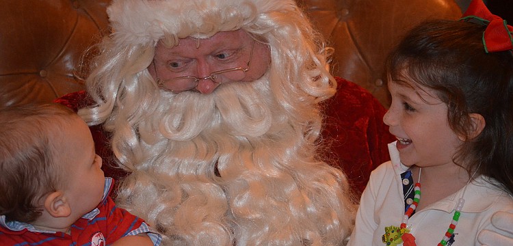 Finley and Madison Anderson tell Santa what they want for Christmas