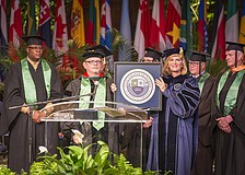 The SCF District Board of Trustees, including Vice Chairman Edward Bailey and Chairman Dr. Craig Trigueiro, present the college seal to President Dr. Carol F. Probstfeld during the inauguration ceremony.
