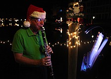 Dockmaster Bob Geraci played Christmas classics on his clarinet as residents walked by his former dock.