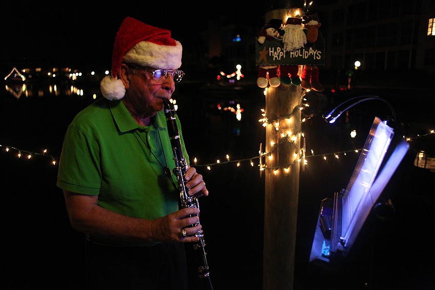 Dockmaster Bob Geraci played Christmas classics on his clarinet as residents walked by his former dock.