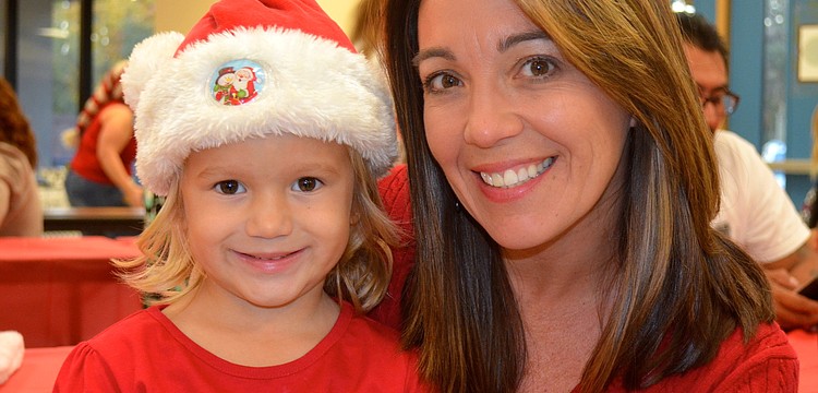 Ally Ridenour, 3, and Michelle Dieter prepare their Christmas lists.