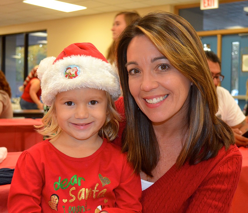 Ally Ridenour, 3, and Michelle Dieter prepare their Christmas lists.