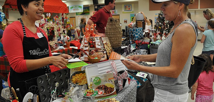 Marie Tannus, of Pampered Chef, shares about her products with Carolyn Talbot.
