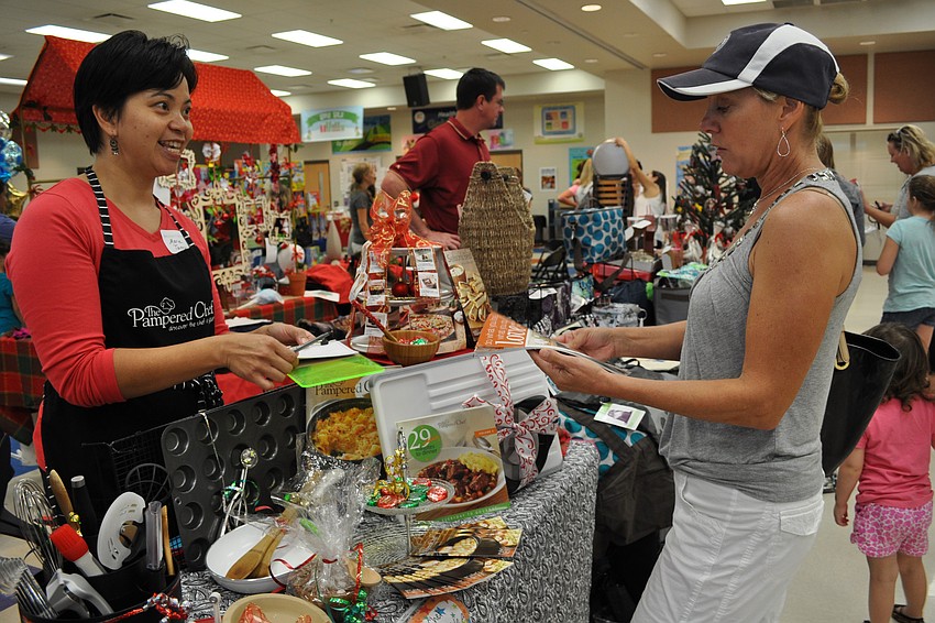 Marie Tannus, of Pampered Chef, shares about her products with Carolyn Talbot.