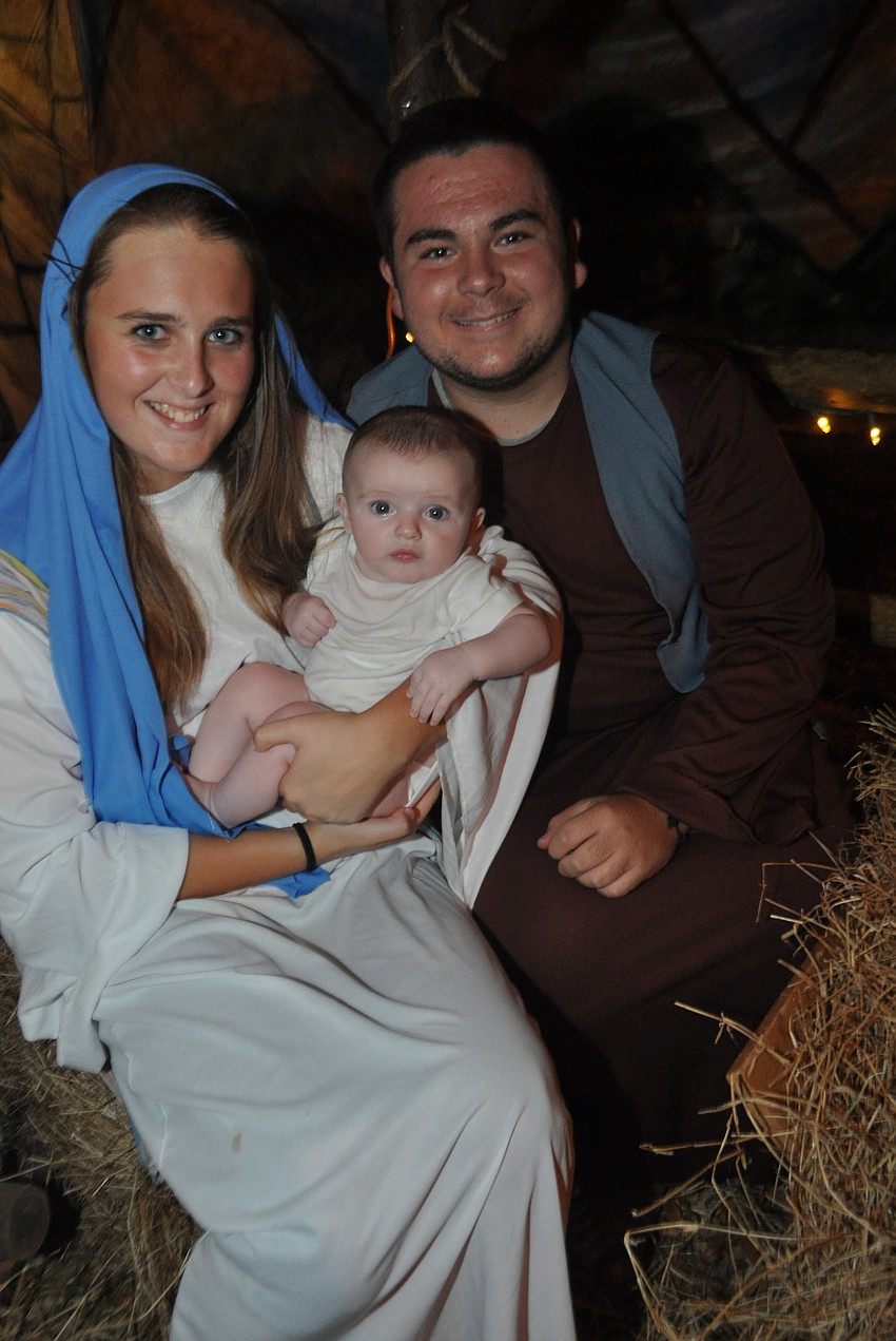 Meghan Neu, Ryan Hitchcock, 3 months, and Danny Riordan play Mary, baby Jesus and Joseph.