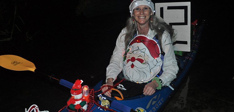 Judy Zolna participates in the parade in her kayak.