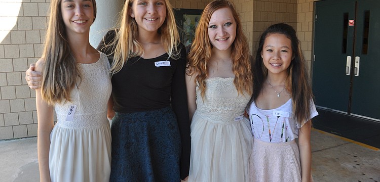 Gabby Alfonso, Alison Volpe, Halee Prater and Kieu Nguyen welcome guests and provide nametags.