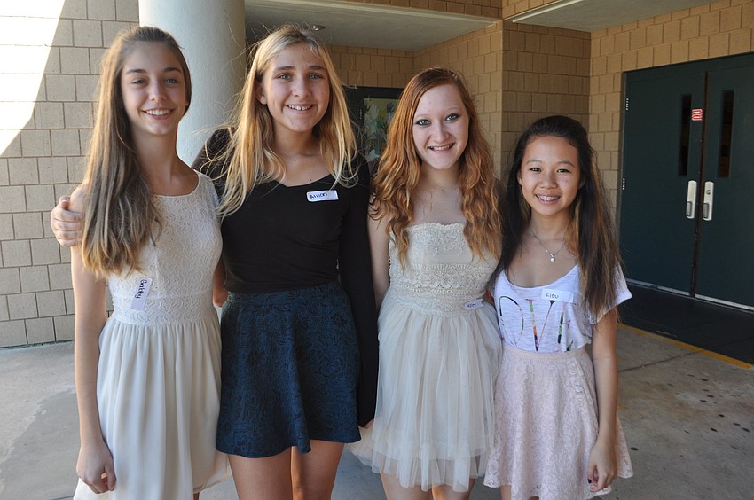 Gabby Alfonso, Alison Volpe, Halee Prater and Kieu Nguyen welcome guests and provide nametags.