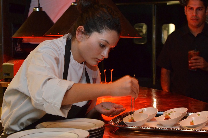 Madison Huang adds chives to Chef Diego Okaâ€™s Snake River Farms Waygu