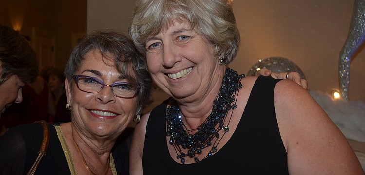 Tamara Tazzia and Linda Flanigan show off big necklaces and smiles.