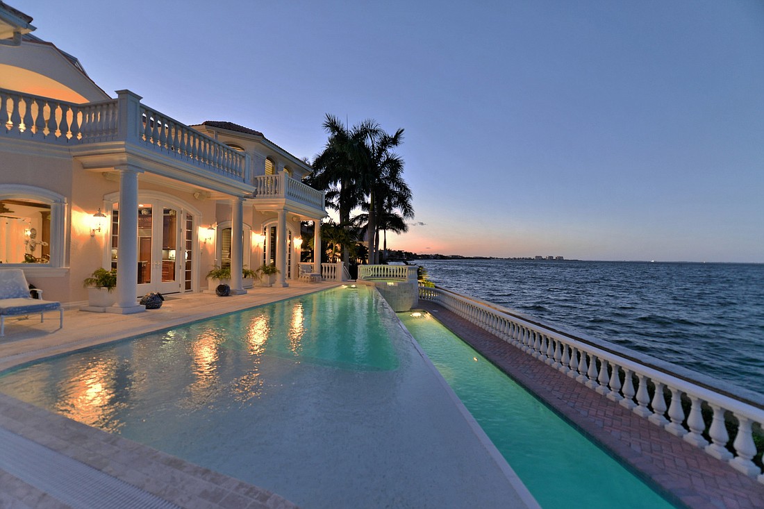 The home features an Infinity pool and overflow lap pool overlooking Sarasota Bay and downtown Sarasota. (Courtesy)