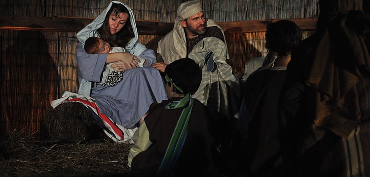 Mary and Joseph, portrayed by Emily Arakel and Joe Mascitto, welcome children to see the newborn child.
