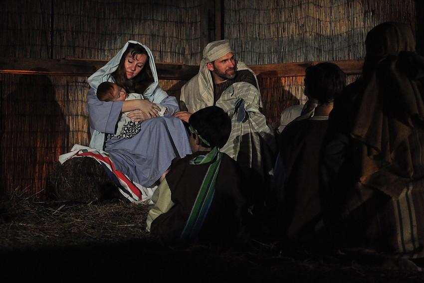 Mary and Joseph, portrayed by Emily Arakel and Joe Mascitto, welcome children to see the newborn child.