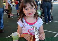 Six-year-old Sam Robbins smiles for a free hot dog.